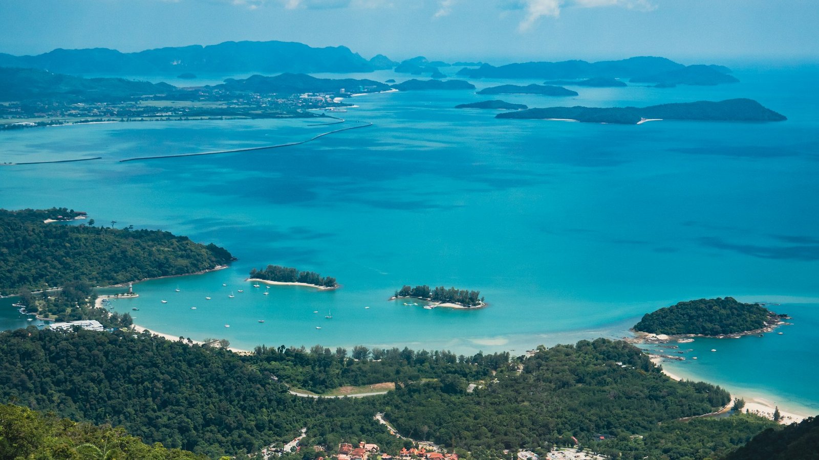 A high vantage point taking in a dozen separate coves and islands at once — the same wide, all-at-a-glance view a good charting platform gives you across markets